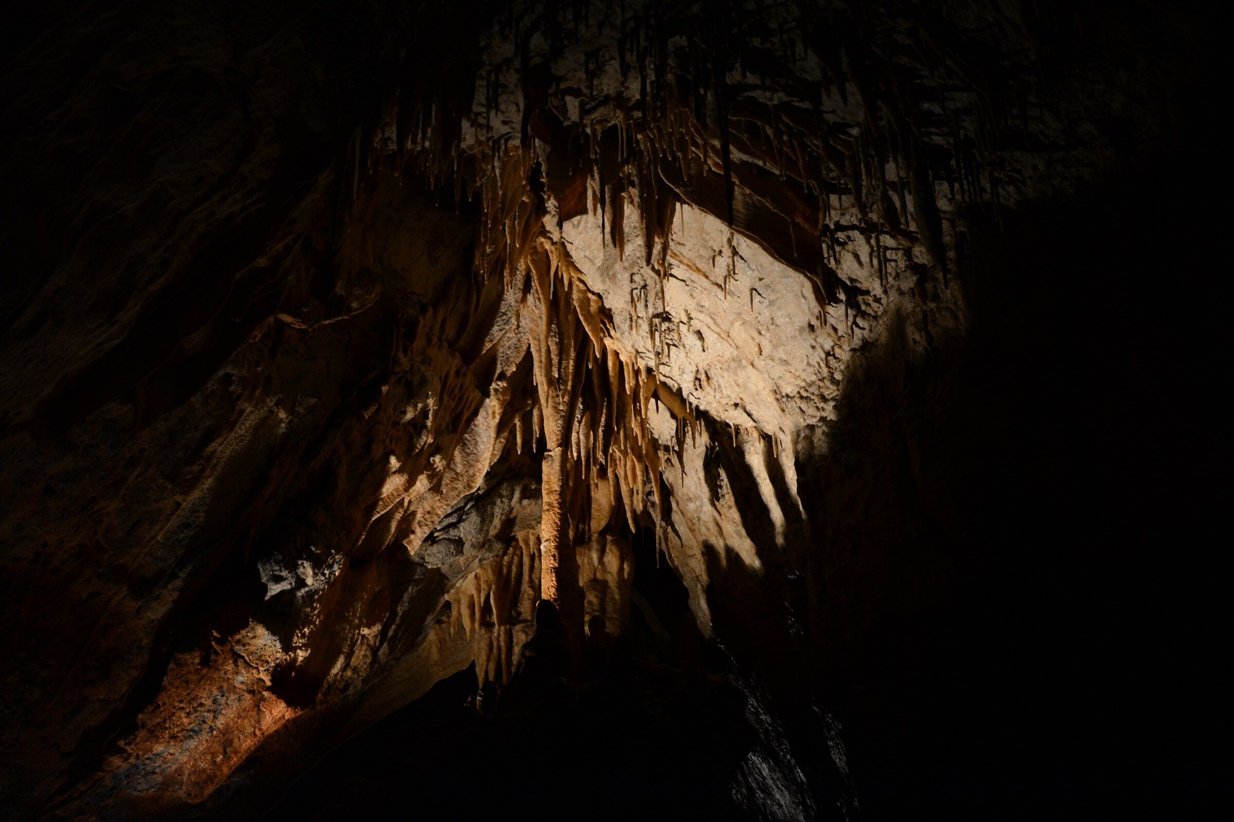 dark room with stalactites in kapsia cave